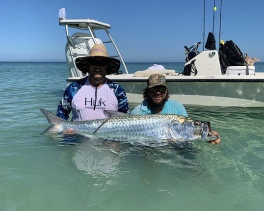 Two fishing man caught and release a tarpon with flats rising in Marathon Florida. FloridaKeysVillas.com