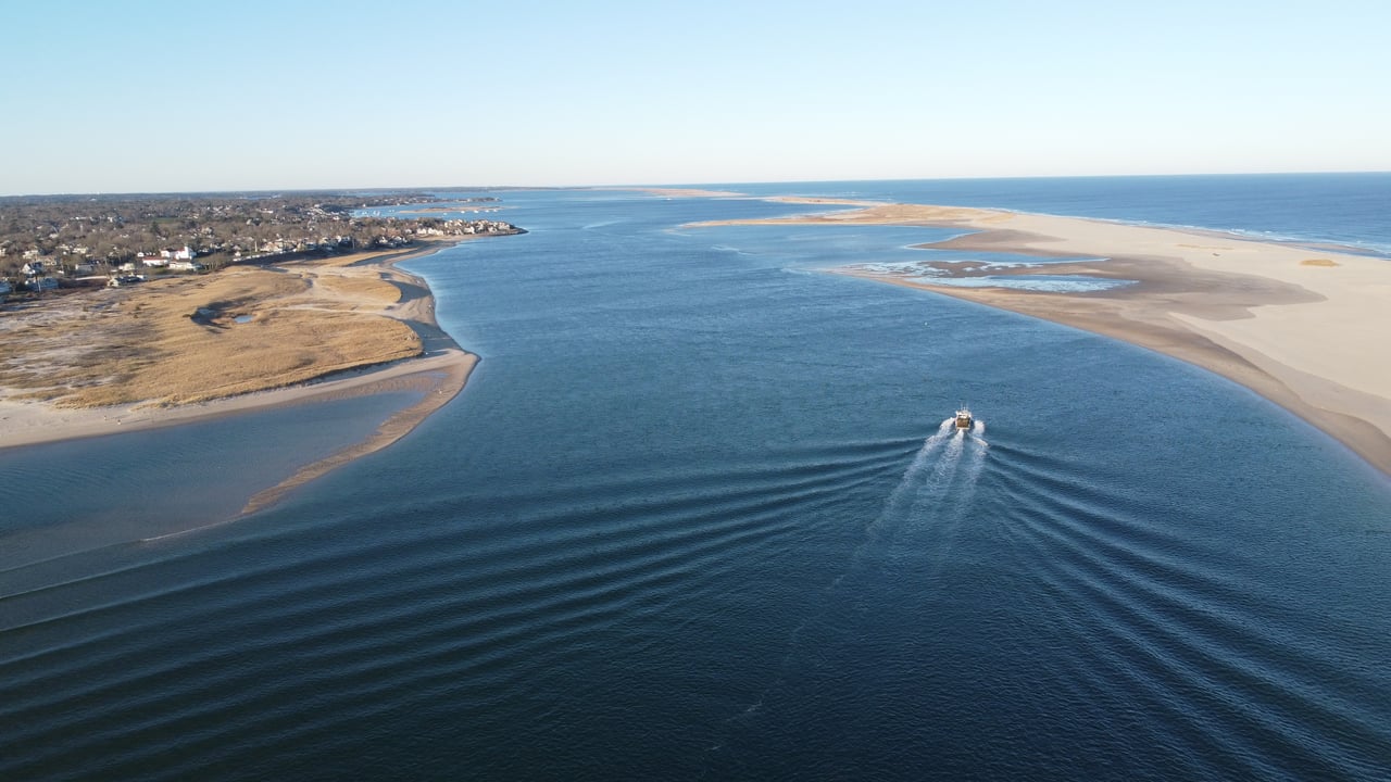 fishing boat heading out to sea in chatham, massachusetts