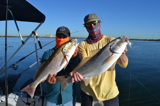 Attison Barnes and Captain Bryan C. of San Antonio showing the spots of a few freshwater redfish.