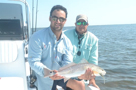 captain experiences jonathan newar holding redfish in aransas pass with captain Larry B