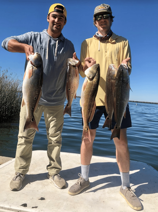 men holding up big freshwater redfish from calaveras lakes