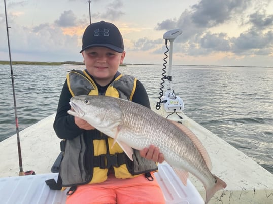 Kid Holding Redfish Inshore Fishing