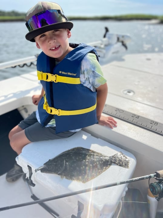 Kid Catching Flounder On Light Tackle