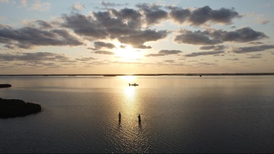 two people casting just after sunrise in Aransas Pass, TX
