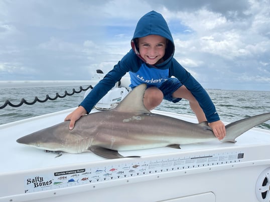 Kid Holding Shark on Boat With Captain Mike