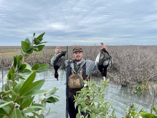Attison Holding Redhead Ducks in Rockport Texas
