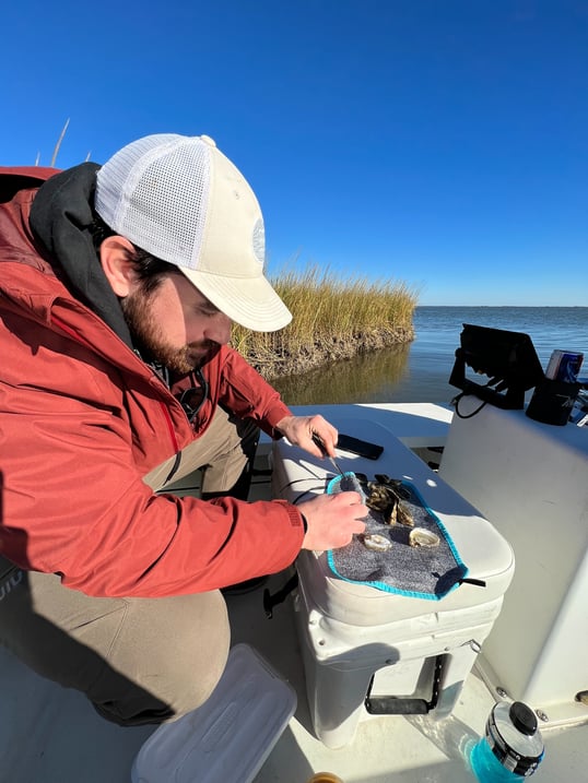 shucking oysters while fishing