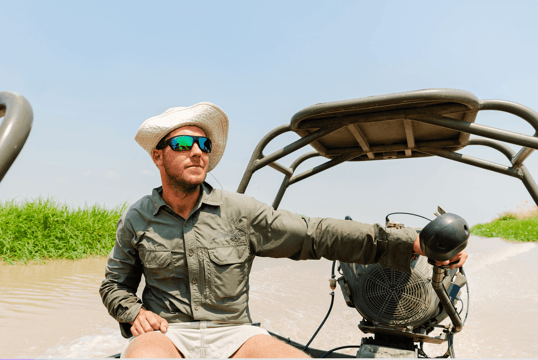 Man steering boat on the river in tanzania