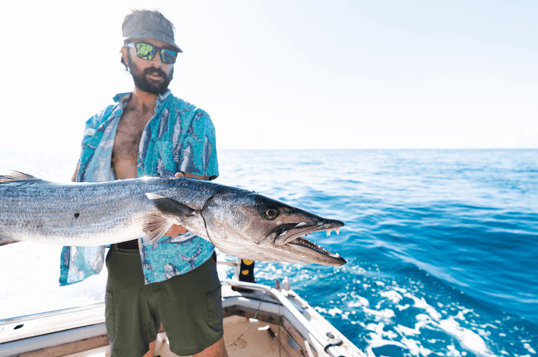 man holding barracuda in tanzania