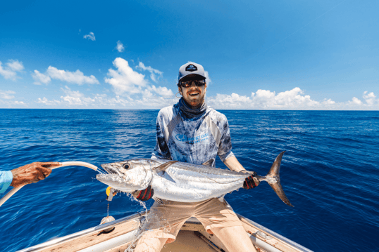 Dogtooth tuna with hose in its mouth